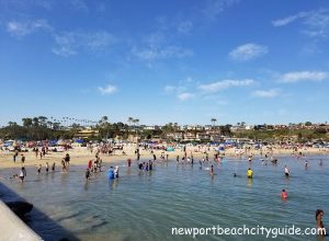 people playing in the ocean corona del mar main beach newport beach www.newportbeachcityguide.com